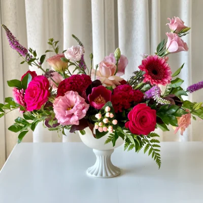 Compote vase with pretty pink and hot pink fresh flowers for centrepieces at weddings in Brisbane Gold Coast